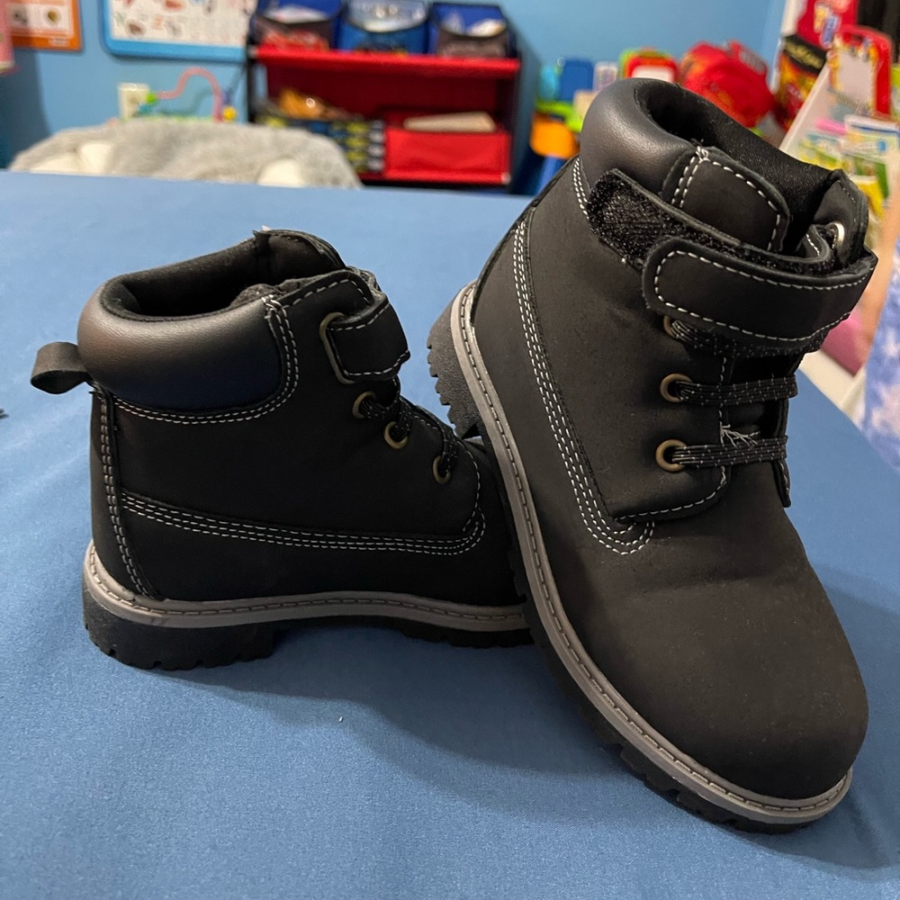 Gray and black pair of boots